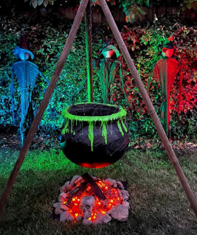 Halloween prop of witches, a cauldron hanging from a tripod and a fake fire
