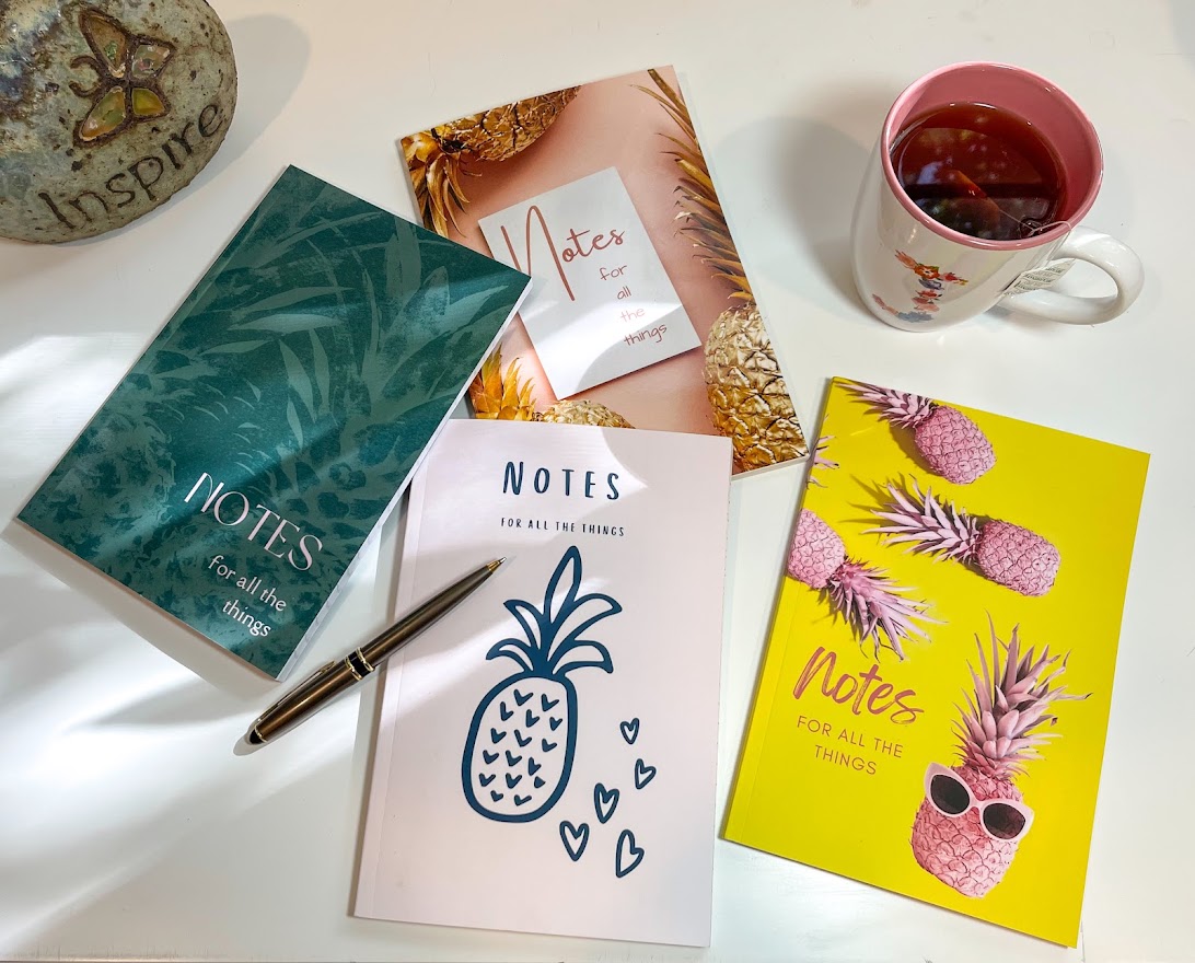 four pineapple notebooks