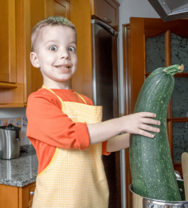 kid with giant zucchini